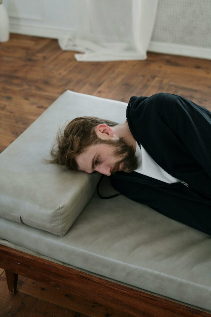 Man resting on a couch after vasectomy